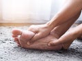 Foot injury use hand massage on feet to relax muscle from heel pain, ankles and bones from inflammation of tendons