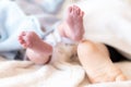 Close-up of the foot of a newborn baby and a one-year-old baby. Feet of infants of different ages sleeping. Foot of a Royalty Free Stock Photo