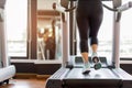 Close up foot sneakers Fitness girl running on track treadmill, Fat woman with muscular legs in exercise gym Royalty Free Stock Photo