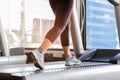 Close up foot sneakers Fitness girl running on track treadmill, Fat woman with muscular legs in exercise gym Royalty Free Stock Photo