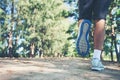 Close up foot of young runner man running along road in the park Royalty Free Stock Photo