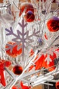 Close-up footage of Christmas Decorations on a Snow-Covered Spruce Tree in dusk, It's snowing, snowflakes are