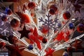 Close-up footage of Christmas Decorations on a Snow-Covered Spruce Tree in dusk, It's snowing, snowflakes are