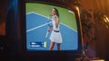 Close Up Footage of a Dated TV Set Screen with Live Sports Tennis Match Broadcast. Athletic Female