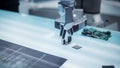Close Up Footage of a Modern Robotic Arm Picking Up and Moving a Microchip. Engineer Interacting