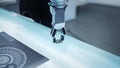 Close Up Footage of a Modern Robotic Arm Picking Up and Moving a Microchip. Engineer Interacting