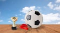 Close up of football ball, golden cup and medal Royalty Free Stock Photo