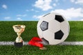 Close up of football ball, golden cup and medal Royalty Free Stock Photo