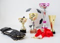 Close up of football, gloves, cups and medals Royalty Free Stock Photo