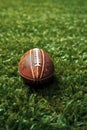 close-up of a football on a grassy field with yard lines Royalty Free Stock Photo