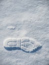 Close up of footprint on white snow. Human footmark of unknown person on ground with precipitation in winter season.