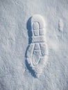 Close up of footprint on white snow. Human footmark of unknown person on ground with precipitation in winter season.