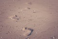 Close up footprints on sand beach in summer vacation seasonal in vintage style.