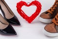 Close up footwear and red heart on white background. Royalty Free Stock Photo