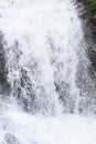 Close up of Forceful Flow of Water with Sprinkling of White Drops Royalty Free Stock Photo