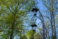 Close-up forged lantern on a spring day in parkland. Iron street lamp. Royalty Free Stock Photo
