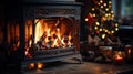 Close-up of a forged metallic fireplace with a large fire and few candles with a blurry luminous Christmas tree in background