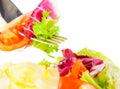 Close-up of fork on italian fresh salad on white