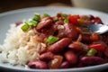 Close-up of a forkful of red beans and rice with diced bell peppers and onions and a sprinkle of cayenne pepper Royalty Free Stock Photo