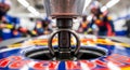 close up of a formula one car during a pit stop, featuring a central locking mechanism and blurred pit crew in the background Royalty Free Stock Photo