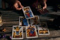 Close-up of a fortune teller displaying some tarot cards on a wooden table Royalty Free Stock Photo