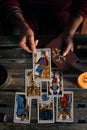 Close-up of a fortune teller displaying some tarot cards on a wooden table Royalty Free Stock Photo