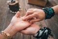 Close up of fortune teller point her finger to woman`s palm line and read her fortune. Palmistry cpncept. Royalty Free Stock Photo