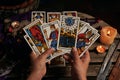 Close-up of a fortune teller reading tarot cards