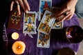 Close-up of a fortune teller reading tarot cards on a table with purple tablecloth Royalty Free Stock Photo