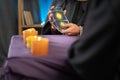 Close-up of a fortune tellers hand holding tarot cards over a table with candles, a future prediction session for a