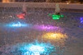 Close-up on a fountain with colored lights in the form of a dome spraying water Royalty Free Stock Photo