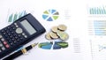 Close up of fountain pen with calculator and money coins on document chart Royalty Free Stock Photo