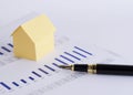 Close up of Fountain pen and house paper on chart for loan money Royalty Free Stock Photo