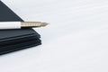 Close up of fountain pen on pile of paperwork on white desk top with mock u place. Luxury a,d stationery concept.