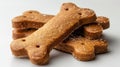 Close-up of four bone-shaped dog biscuits, stacked on a white background Royalty Free Stock Photo
