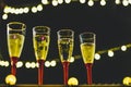 Close up of four glasses with champagne the night of the new year ready to celebrate it - night and dark background Royalty Free Stock Photo