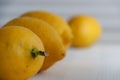 Close-up of four lemons, the first focused, the others unfocused