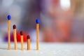 Close up of four matches on bright and colorful bokeh light background. Parenting and family concept. Stand together. Royalty Free Stock Photo