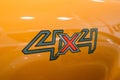 Close up Four-wheel drive 4x4 sign on a new orange Ford Ranger
