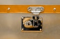 Close-up fragment of locks and fasteners on the vintage leather and metal suitcase brown Royalty Free Stock Photo