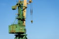 Close-up of a fragment of a port sea crane against the blue sky