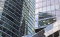 Close-up fragment of transparent glassy walls reflecting sky with clouds. Modern architecture Royalty Free Stock Photo