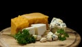 Close up for french delicious aged cheeses choped and served on wooden board isolated on black background. Frame Royalty Free Stock Photo