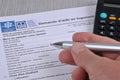 Completing a french housing assistance application form with a pen