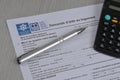 French housing assistance application form with pen and calculator