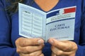 Woman checking a French electoral map in close-up