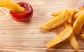 Close up of french fries with ketchup on rustic wooden background Royalty Free Stock Photo