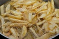 Close-up of French fries potatoes frying in boiling hot oil in a deep fryer at home. French fries, Junk food concept, home made Royalty Free Stock Photo