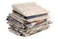 Pile of newspapers close up on white background