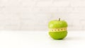 Close up fresh apple shape dieting with tape measure. Royalty Free Stock Photo